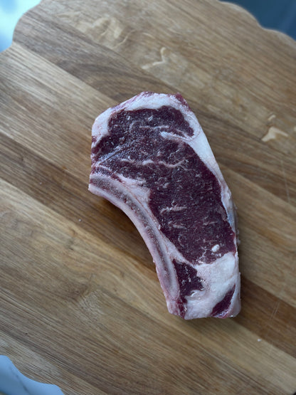 Elkins Cattle Co. grass-fed bone-in ribeye steak with natural marbling
